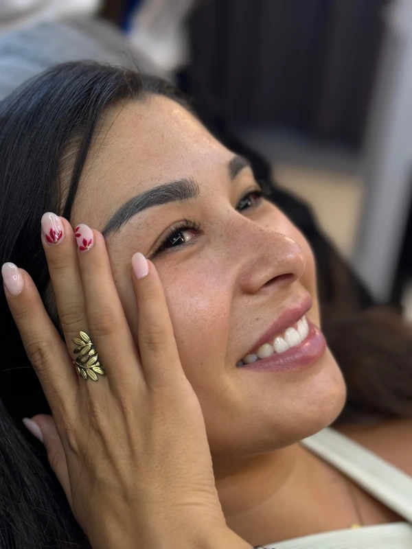 Pink French tip nails with delicate floral detail